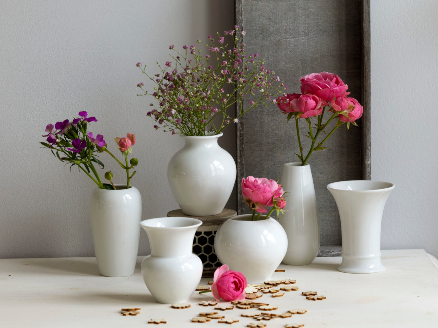 Six small white porcelain vases decorated with purple flowers from Hutschenreuther Flower Minis
