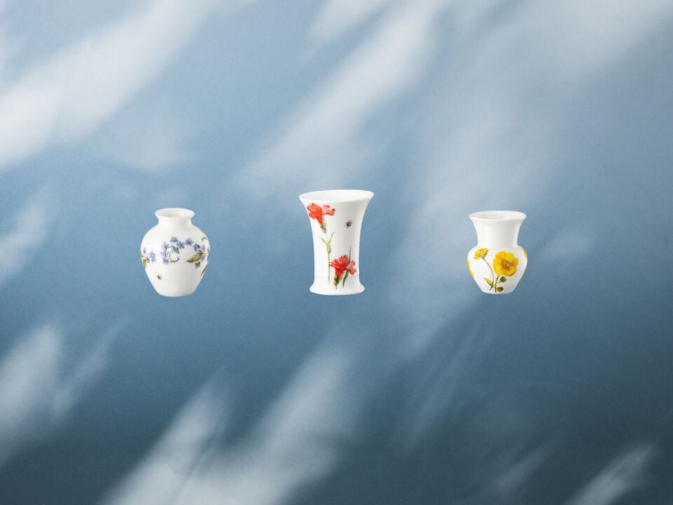 Three different Vases with different floral decors on blue background