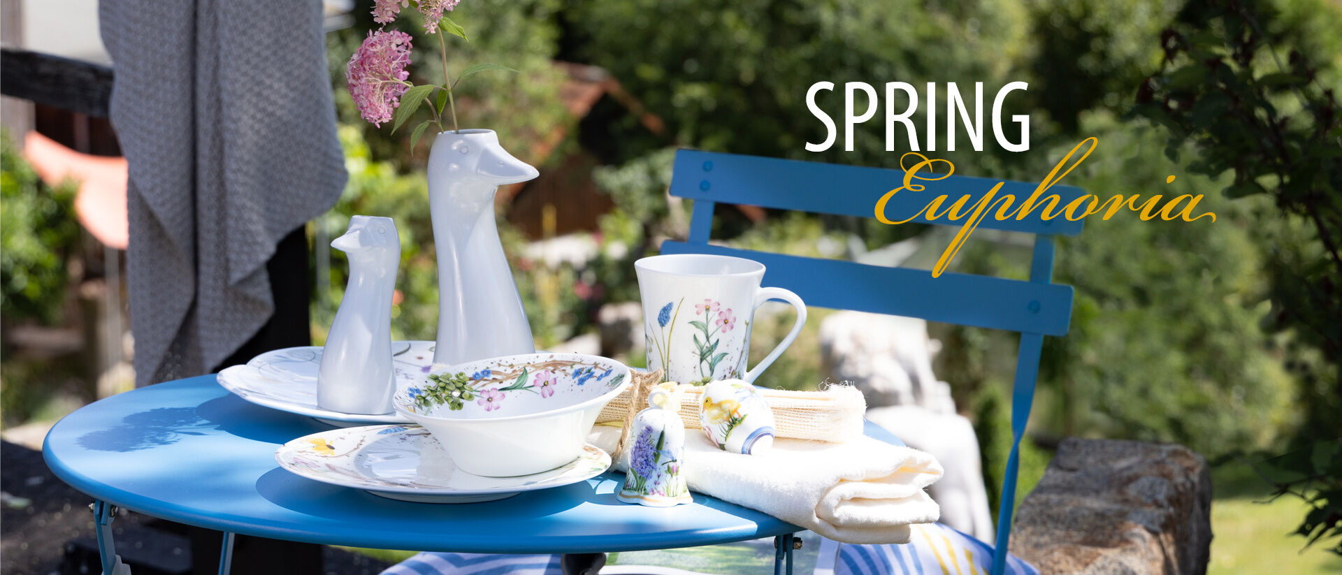 Hutschenreuther spring collection on blue table in a garden