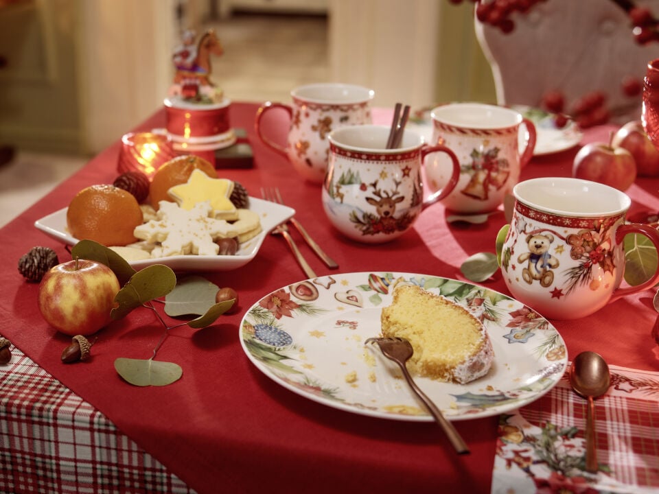 Table de No&euml;l dress&eacute;e avec une assiette contenant une part de g&acirc;teau.