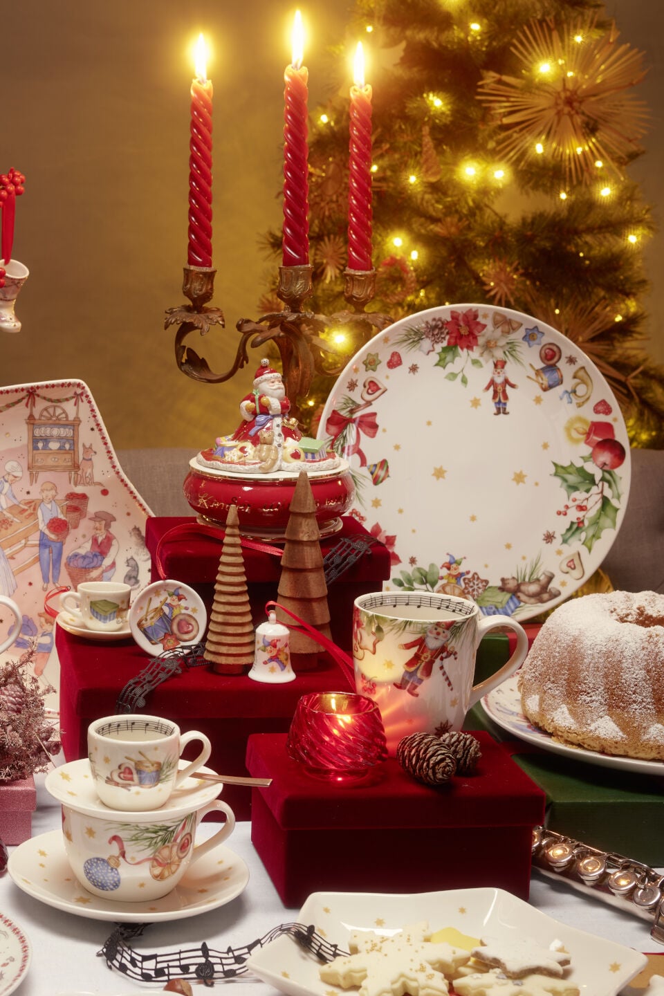 Set christmas table with a plate, decoration, mugs and candles