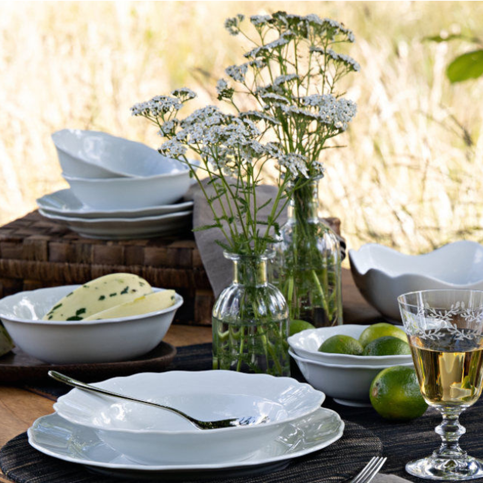 ummer table with white porcelain, melons and wildflowers.