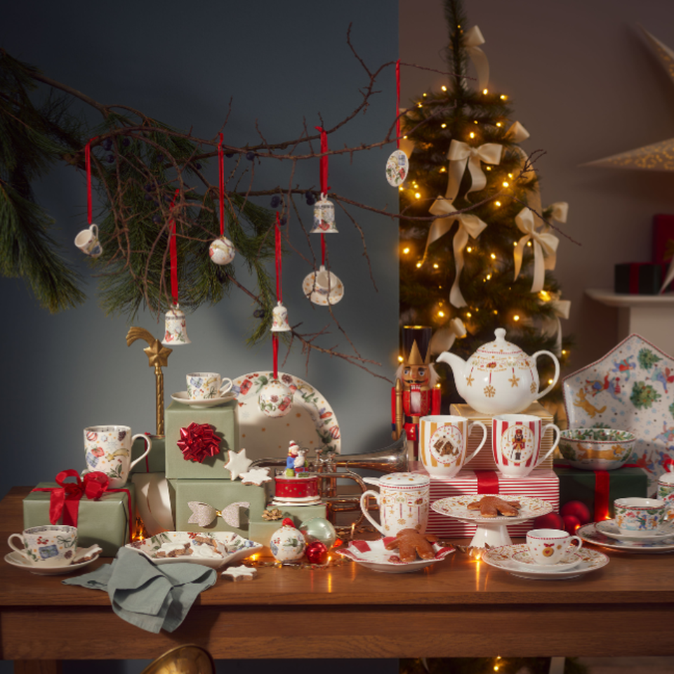 Hutschenreuther Christmas collections on a laid table: red and white porcelain with festive decorations