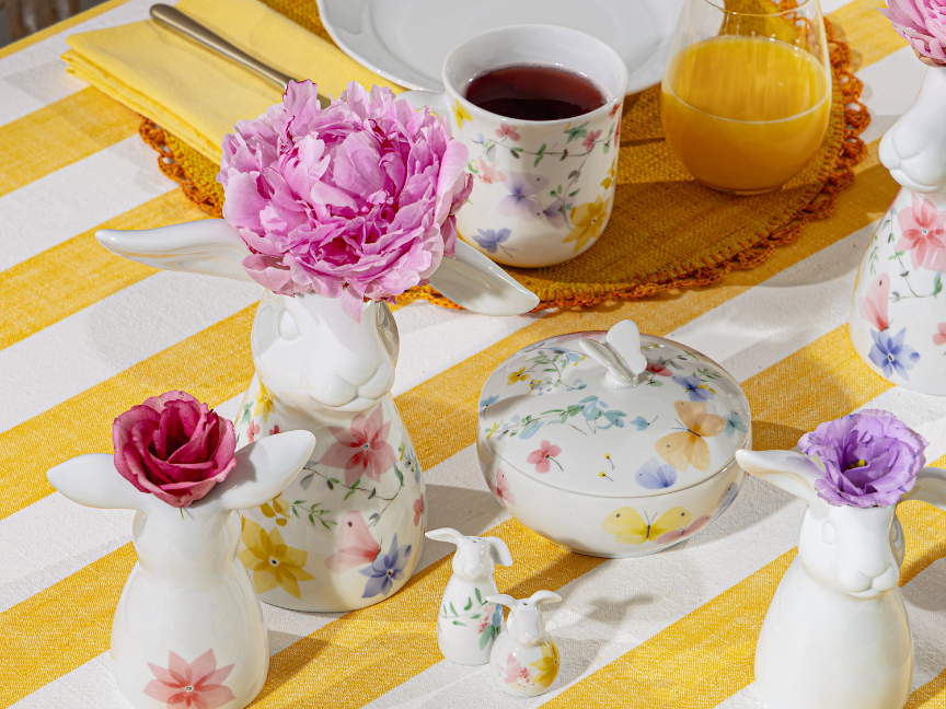 Hutschenreuther Easter porcelain with floral motifs, rabbit vase with peony and decorative box on a spring-themed table setting.