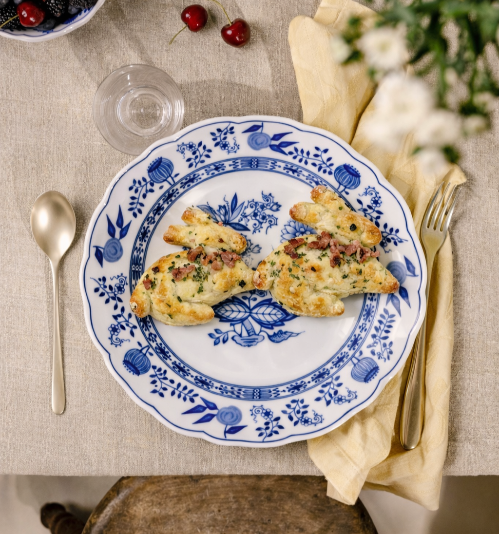 Puff pastry Easter bunnies with cheese and bacon on blue and white Hutschenreuther porcelain plates.